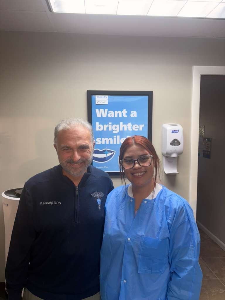 Dr. Kasabji and dental assistant smiling